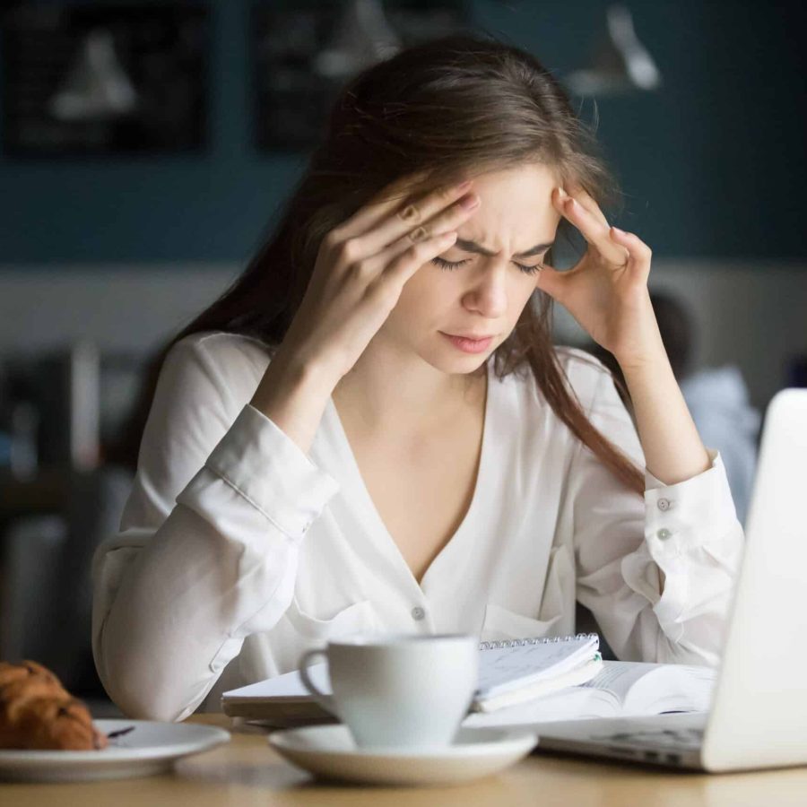 nervous-stressed-female-student-feeling-headache-studying-in-cafe-scaled.jpg